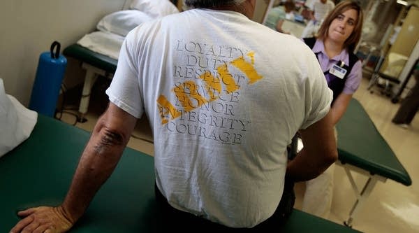 Robert Wake, an Iraq war veteran suffering from post-traumatic stress disorder, talks to physical therapist Nicole Bormann before a session in the VA Medical Center August 10, 2009 in St Louis, Missouri. 