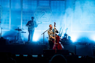 Two musicians performing on an outdoor stage