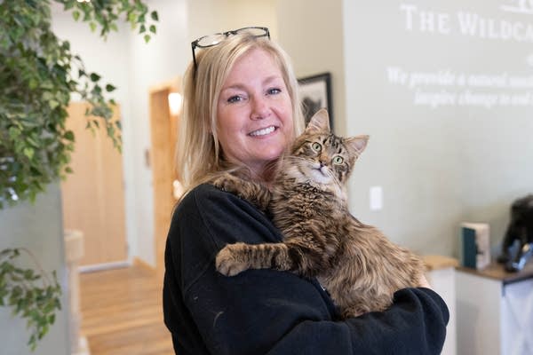 A woman holding a cat