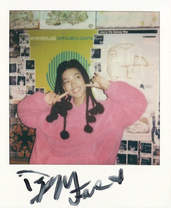 dizzy fae poses for a polaroid photo