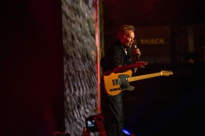 A musician addresses an audience