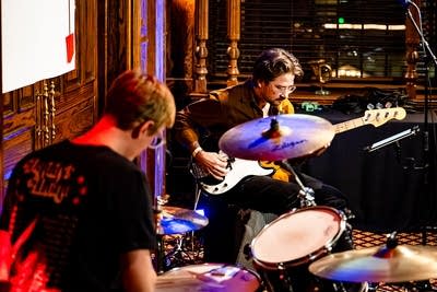 Two musicians performing together in a pub