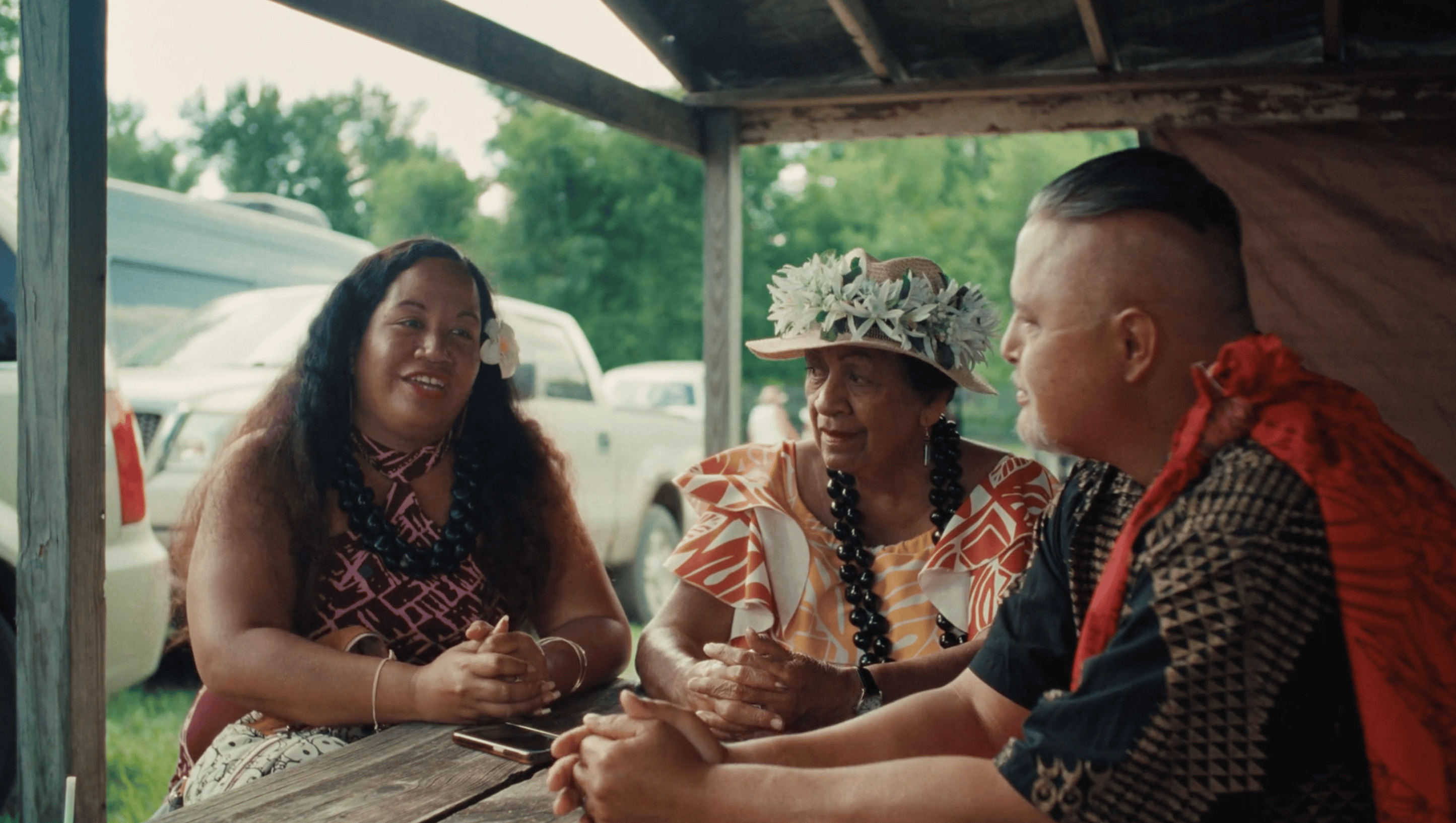 Three people sit at a table
