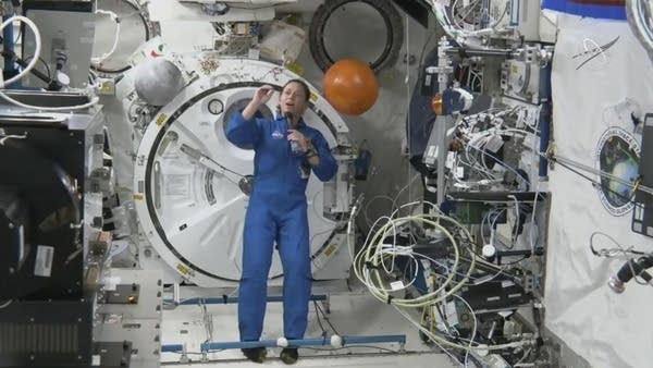 Person stands in space station