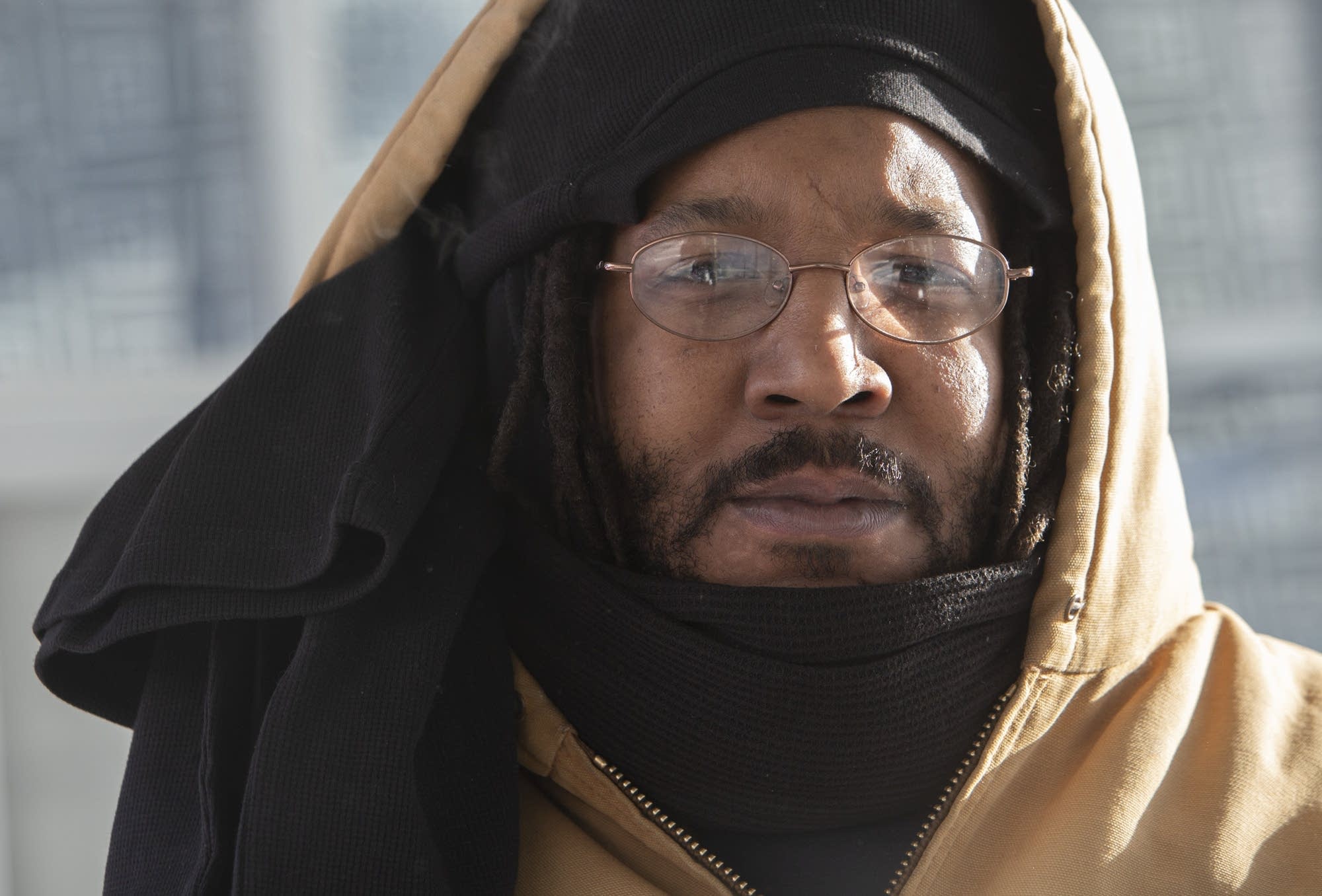 Dandre Pernell ties three thermal knit shirts around his head to keep warm
