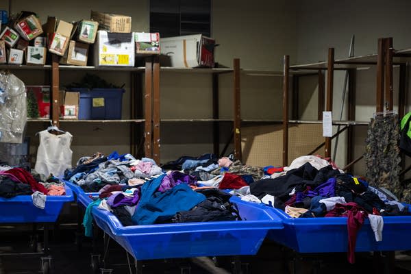 Used clothes sit in blue bins