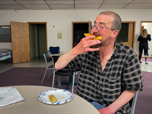 A man eats pizza