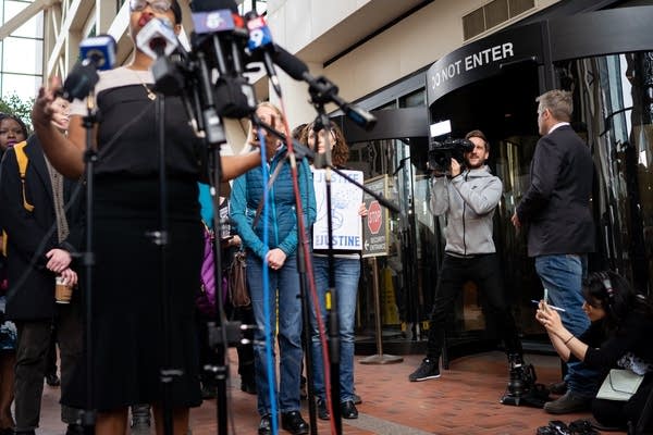 An Australian reporter and photographer film a standup shot.