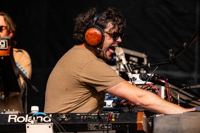 Passion Pit performing on an outdoor stage.