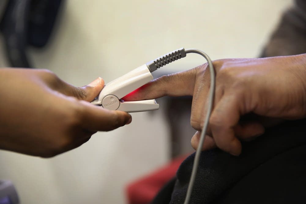 A health worker gives a physical exam