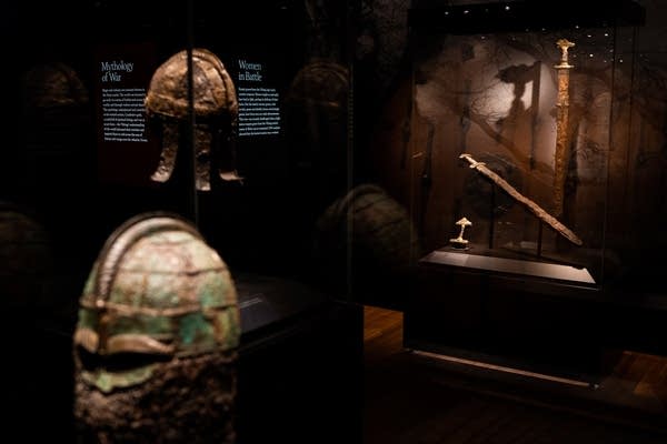 Viking helmets and swords sit on display.