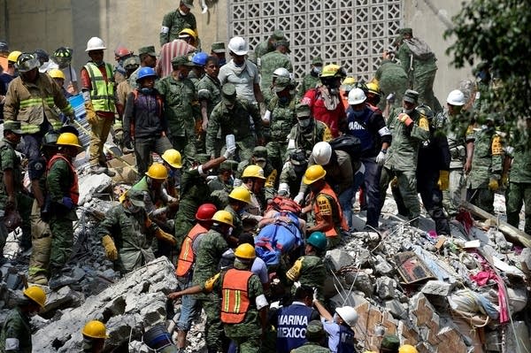 A man is pulled out of the rubble alive in Mexico City.