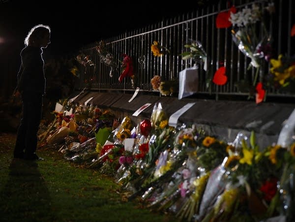 Mourners pay their respects at a makeshift memorial