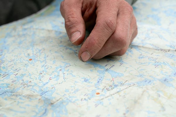 A man points on a map