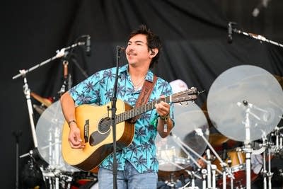 wyatt flores performing with his band at an outdoor show