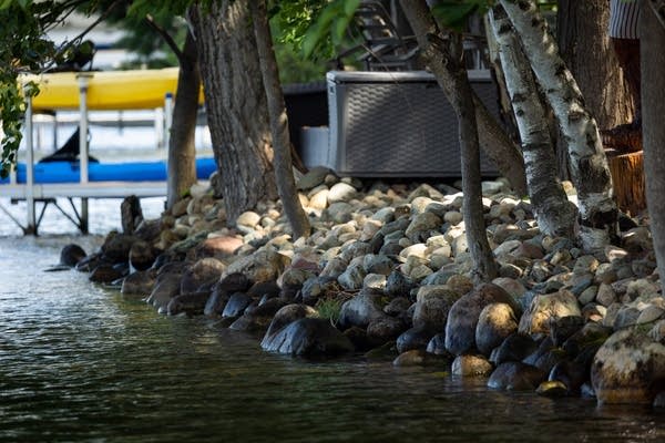 Rocks line a lakeshore
