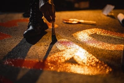 A hand paints