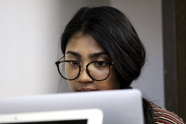 A person looking at a computer. 