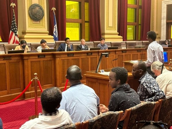 People sit in a courtroom