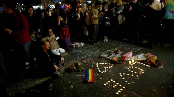 People attend a candlelight vigil for the victims of the Pulse Nightclub shooting in Orlando, Florida. Fifty people were killed and 53 injured after a gunman opened fire on people in a gay nightclub in Florida. It is the deadliest mass shooting in US history.