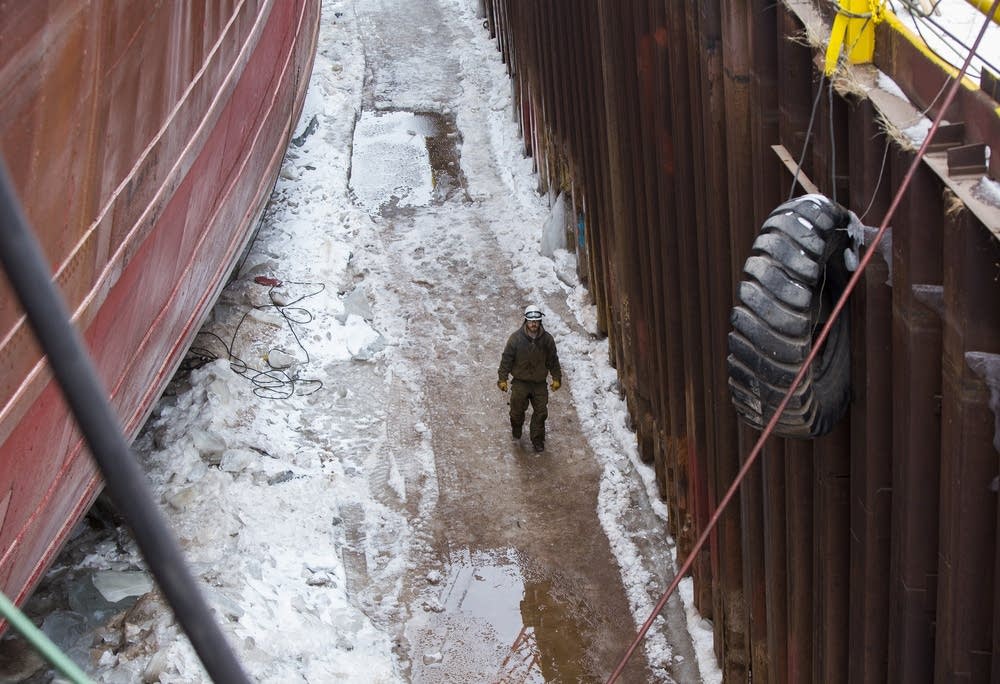 A worker walked along the hull.
