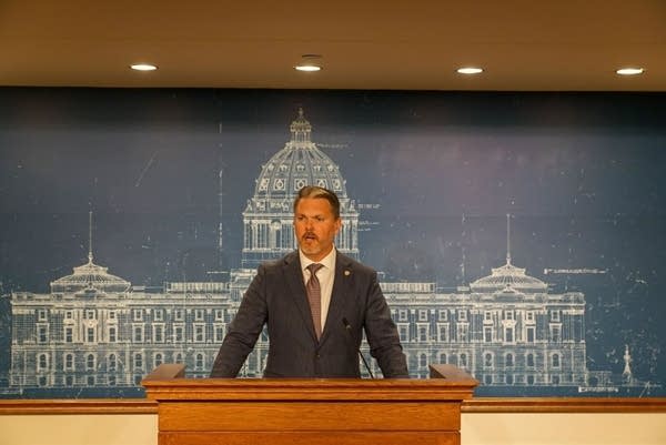 A man stands behind a podium.