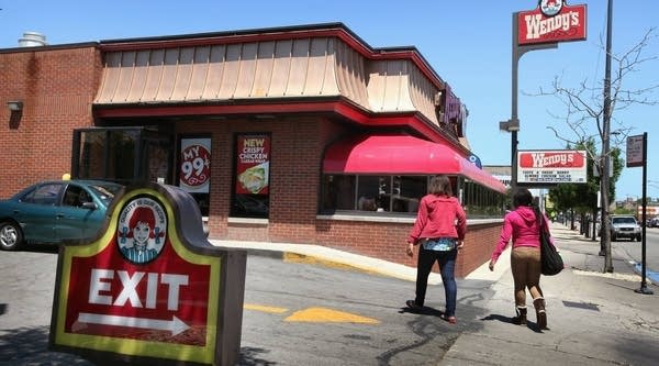 Customers walk to a Wendy's restaurant on June 13, 2011 in Chicago, Ill. The company experienced big losses last quarter, in part because of rising food prices.