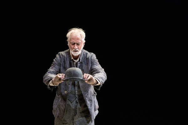 An actor in a play holds his hat in his hands.