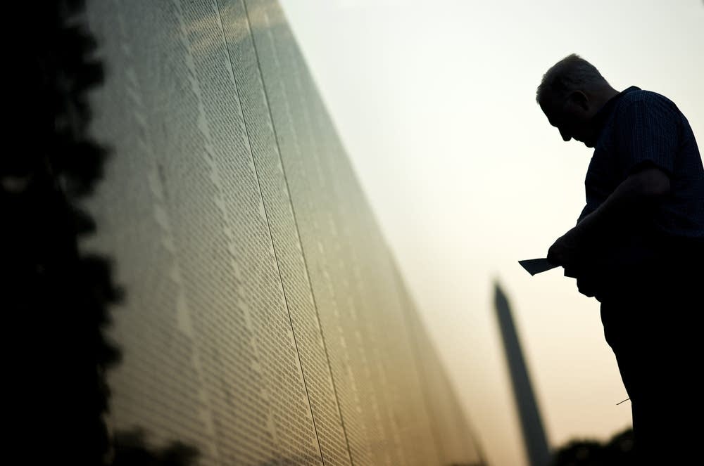 A man visits the Vietnam Memorial Wall M
