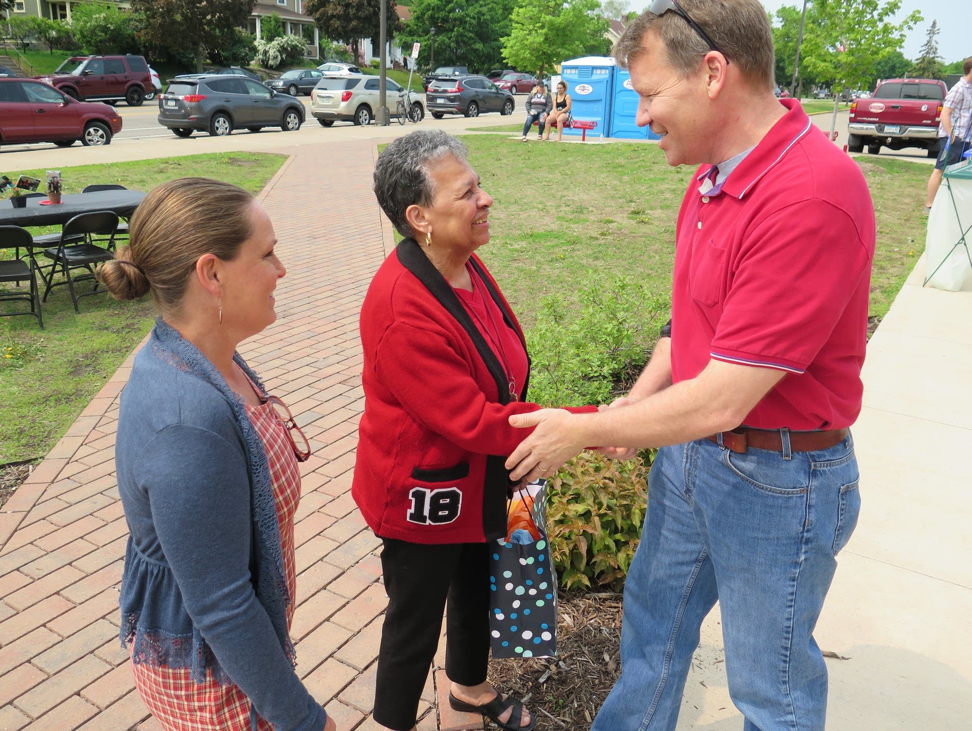 Jeff and Dawn Pauls congratulate St. Paul Central Principal Mary Mackbee