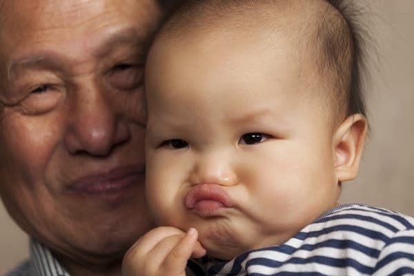 A stock image depicting a grandfather with his grandson