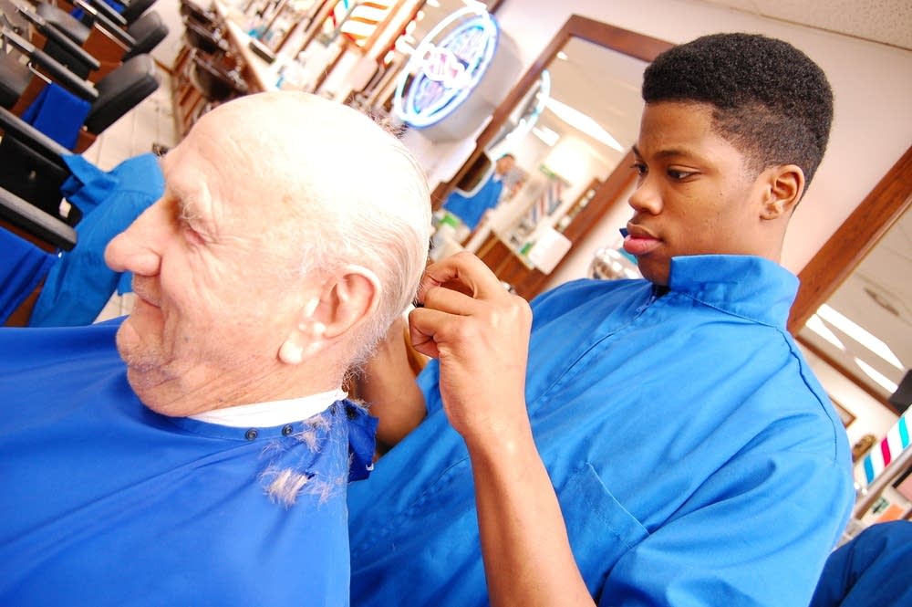 Barbering student with a customer