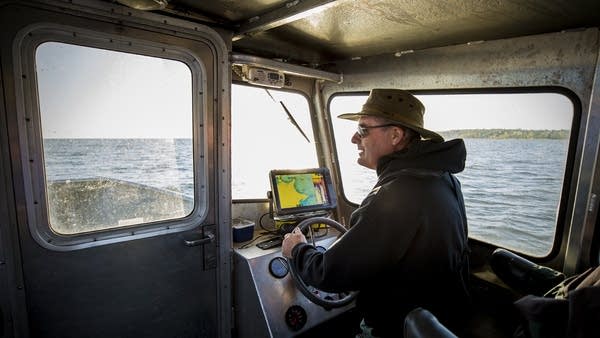 Tom Jones navigates the waters of Mille Lacs searching for DNR nets.