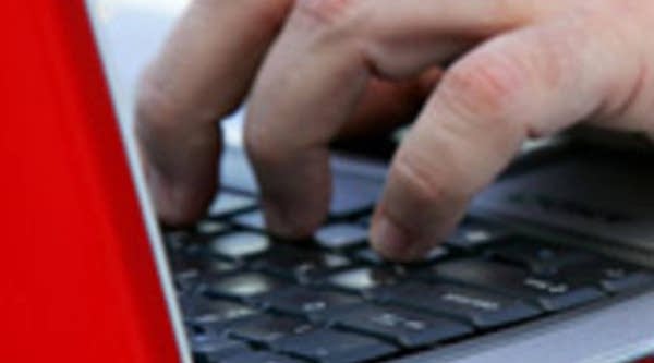 A laptop user typing