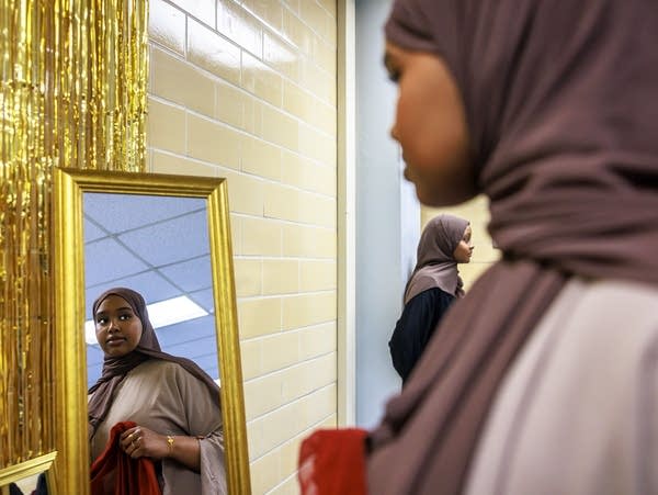 A person tries on a hijab