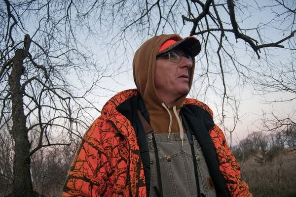 Dave Sanders looks for deer in his hunting grove.