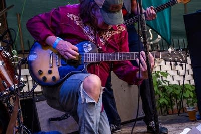 Guitarist kneeling playing guitar