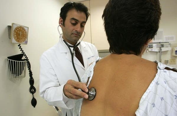 Doctor examines patient