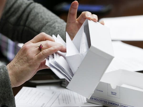 Rep. Marion O'Neill looks through a sexual assault evidence collection kit