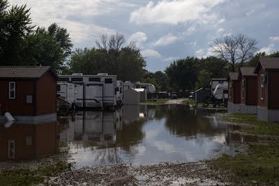 recreational vehicles and cabins are partially submerged in water