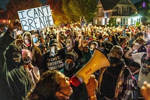 Protesters raise their fists. 