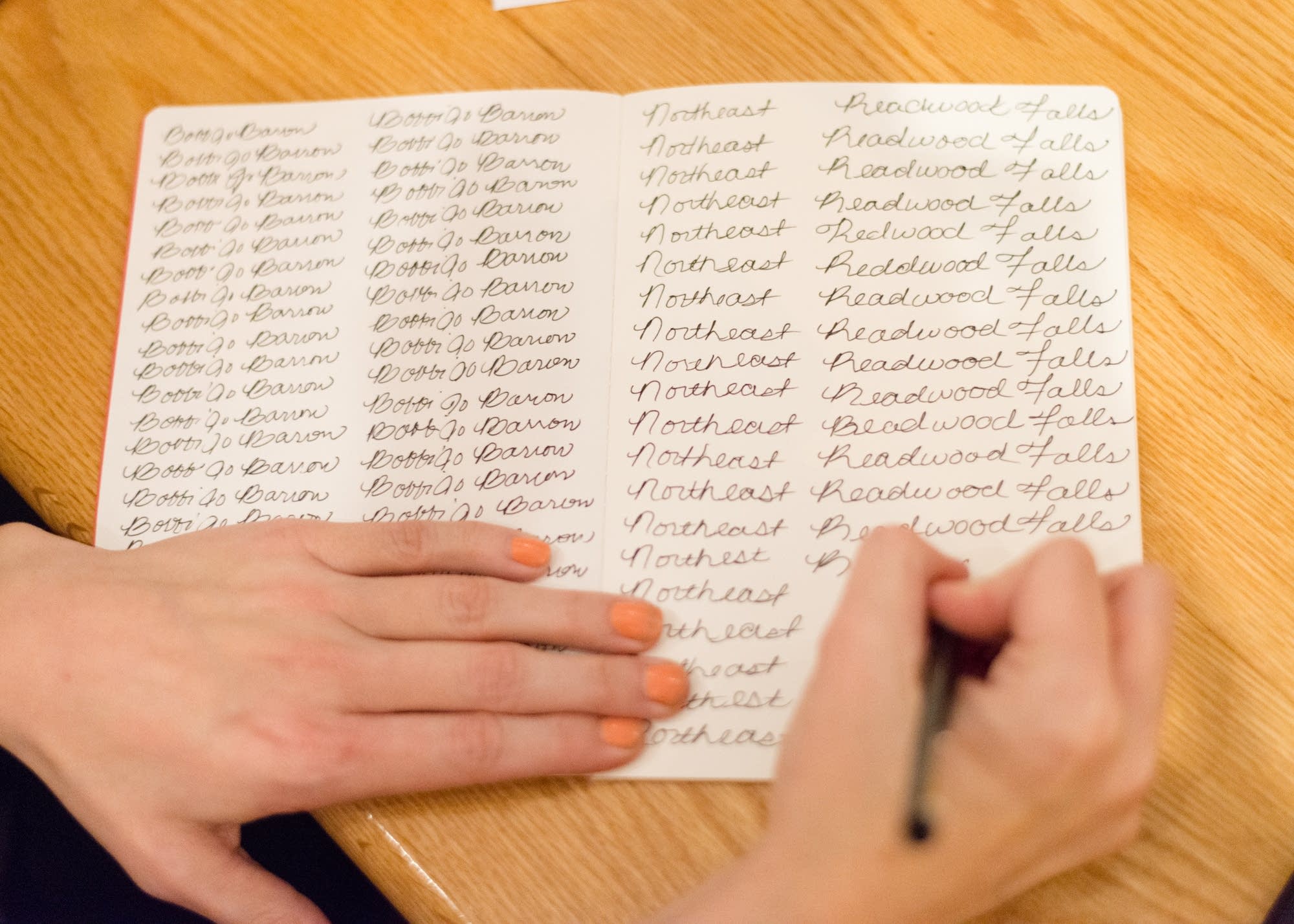 Bobbi Barron practices cursive handwriting.