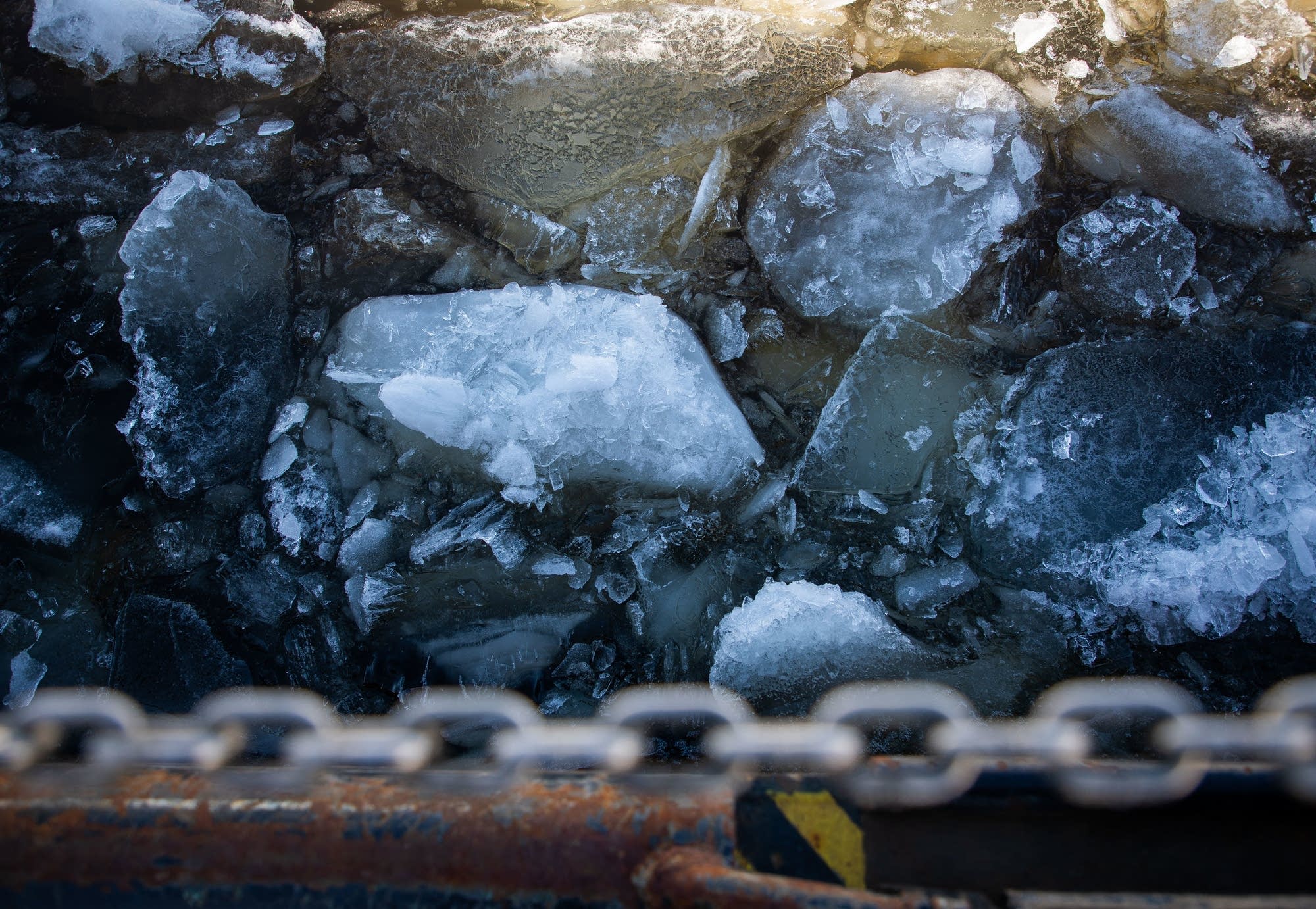 Chunks of ice as thick as a foot or more float by the ice cutter