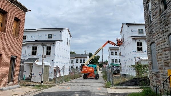 A new low-income rental development rises down the street from where Black Women Build - Baltimore is renovating houses for homeownership, 