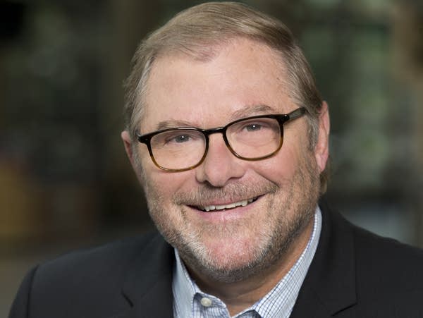 man in glasses and dark sports jacket 