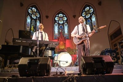 Two musicians performing onstage