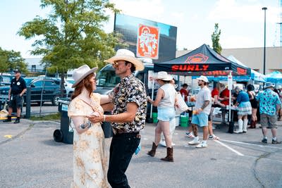Music fans dance at an outdoor music festival