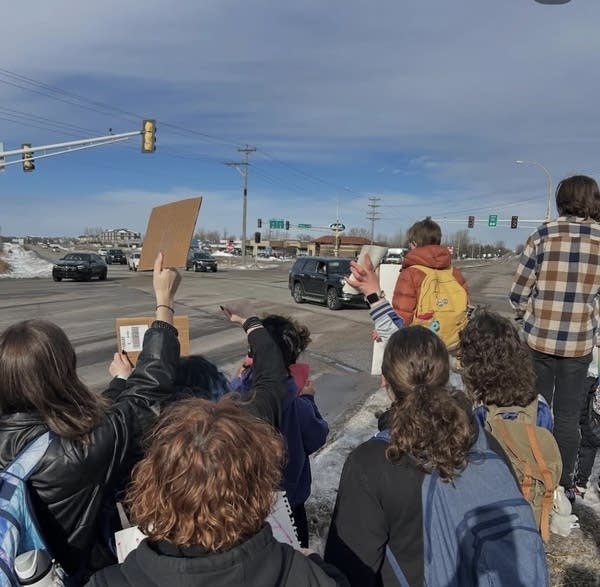 Students protest and hold signs