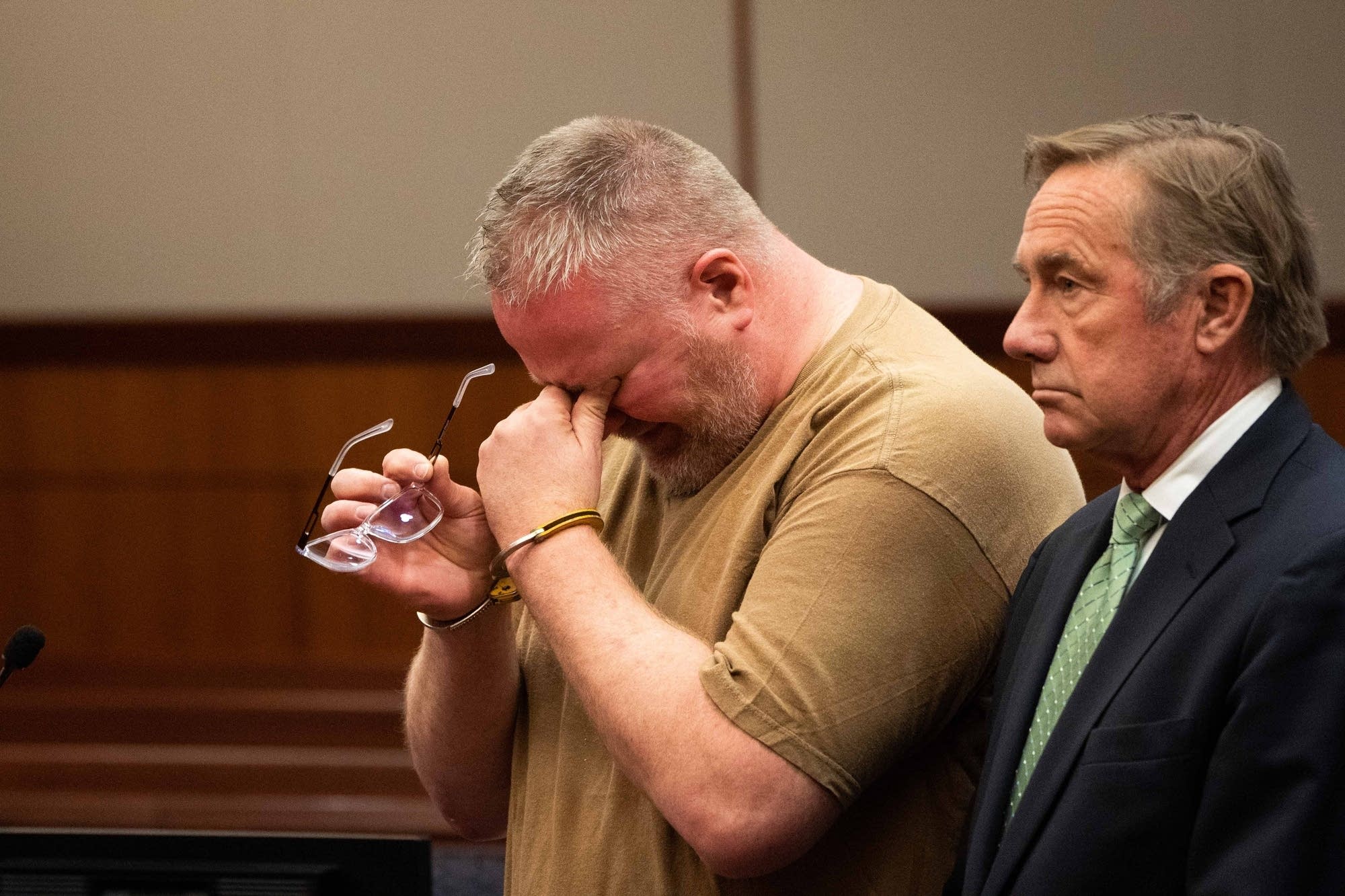 Thompson wipes his eyes as he speaks to the judge