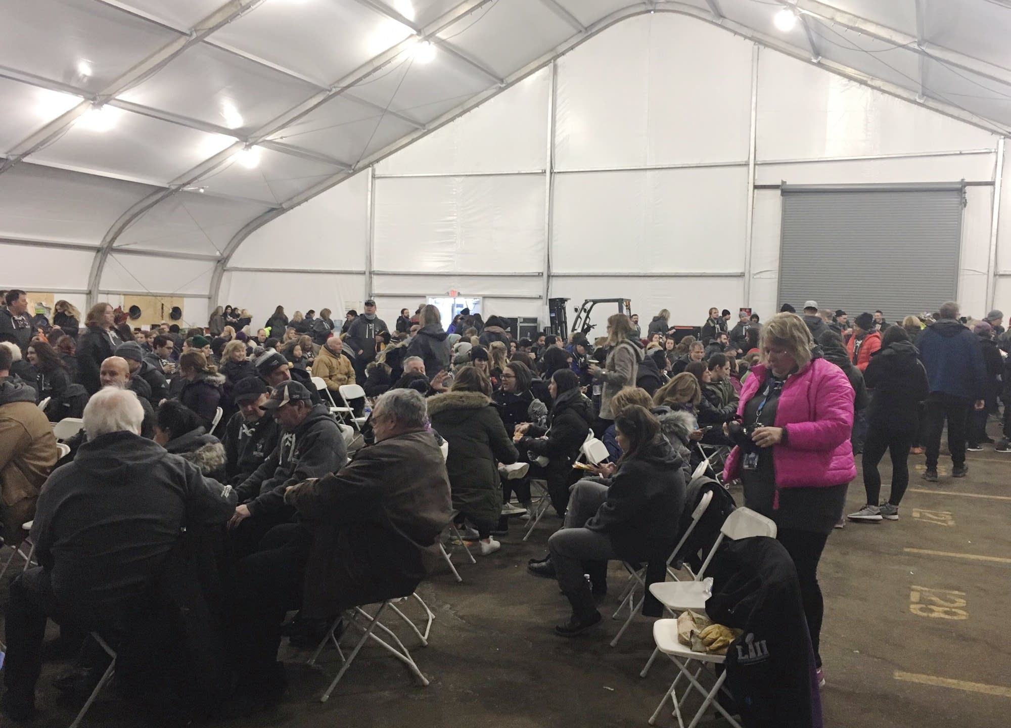 Members of the Super Bowl halftime show field team wait in a tent.